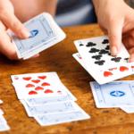person playing solitaire game with cards
