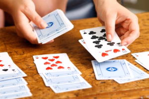 person playing solitaire game with cards