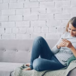 An image of a woman relaxing while looking at her phone